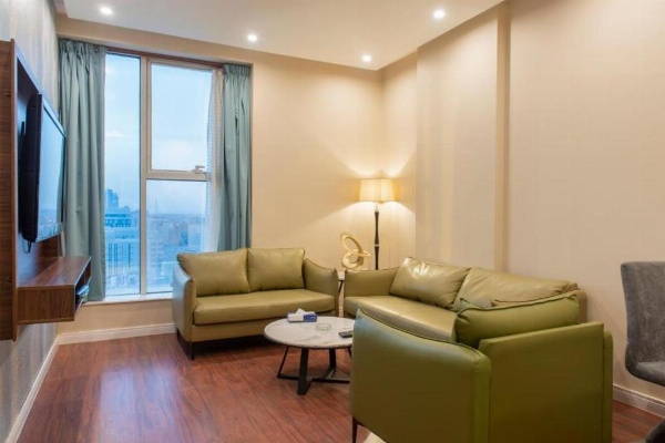 Room with king bed, TV console, and seating in a 3 star hotel in Riyadh Saudi Arabia