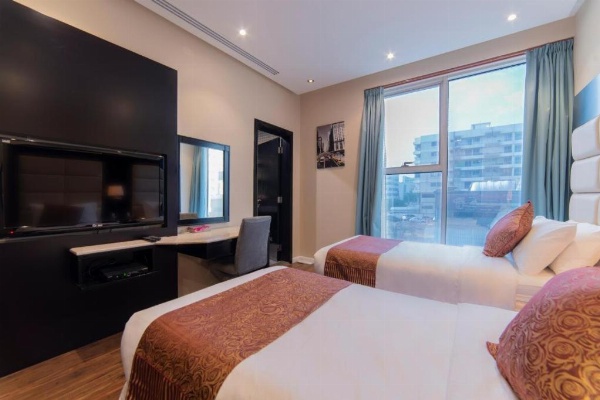 Superior Room with king bed and bench at a 3 star hotel in Riyadh Saudi Arabia