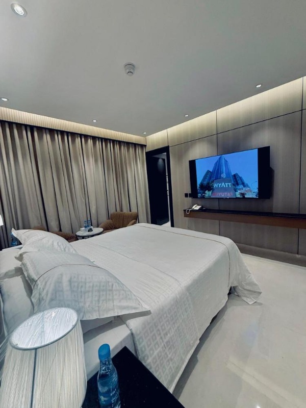 Room with bed and curtain divider at a 3 star hotel in Riyadh Saudi Arabia