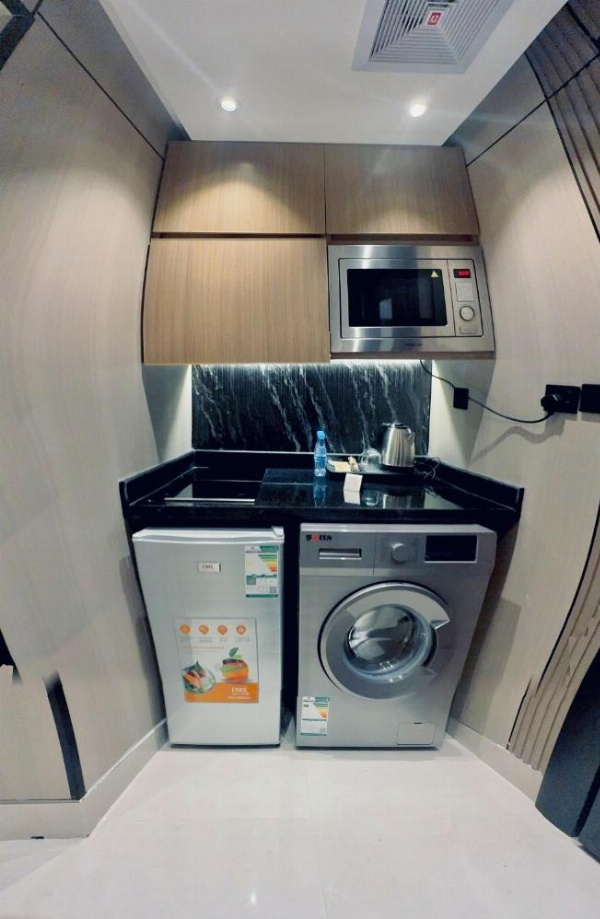 Kitchenette with washer, dryer, and fridge at a 3 star hotel in Riyadh